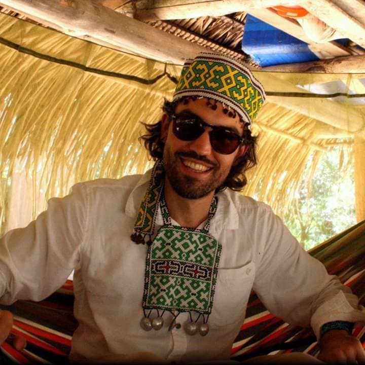 Martin Fortier smiling in a woven cap and sunglasses